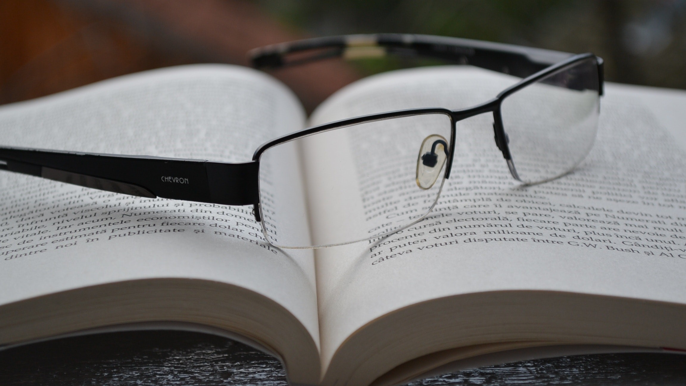 reading glasses placed in an open book