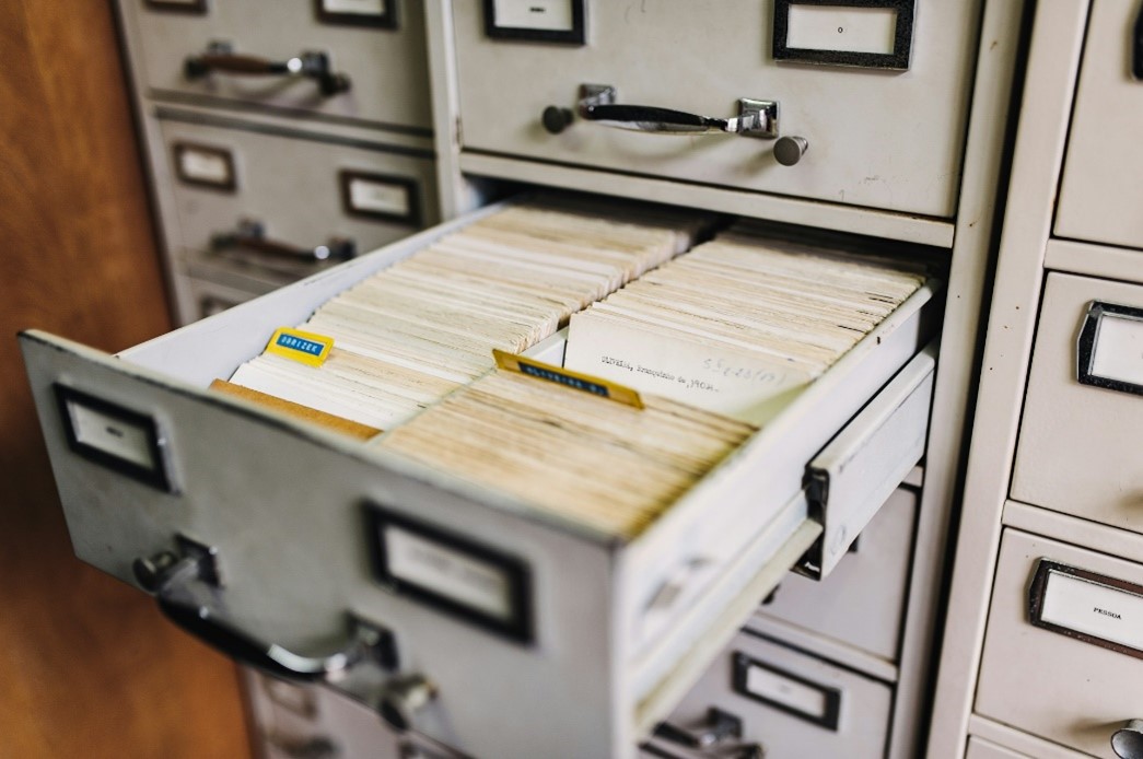 Metal drawers with an open drawer showing index cards inside