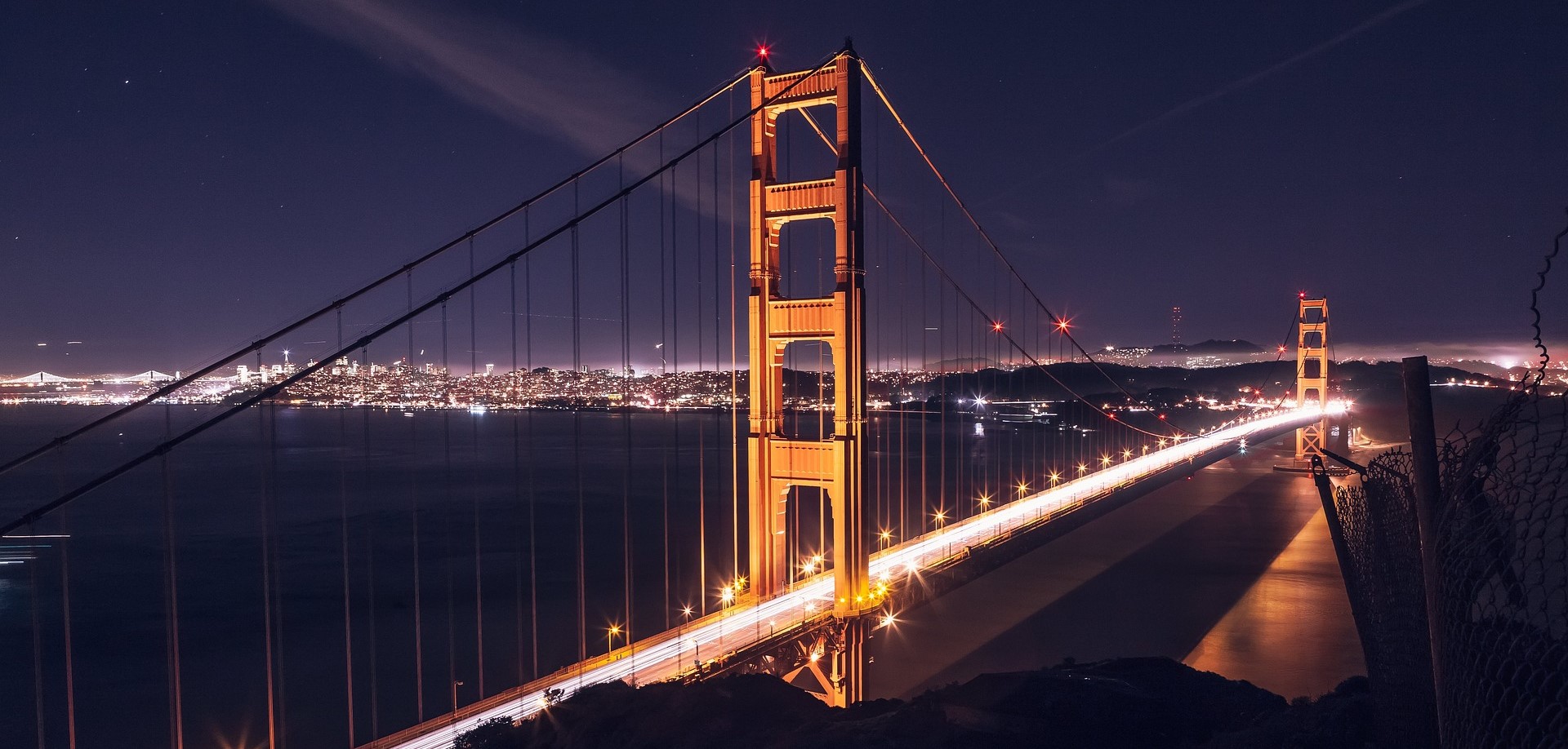 A bridge lit up at night to highlight SharePoint’s architectural features for your intranet.