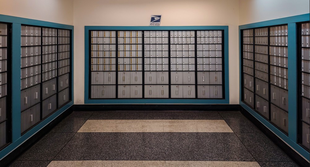 Post office boxes. Rows of locked boxes in a room.